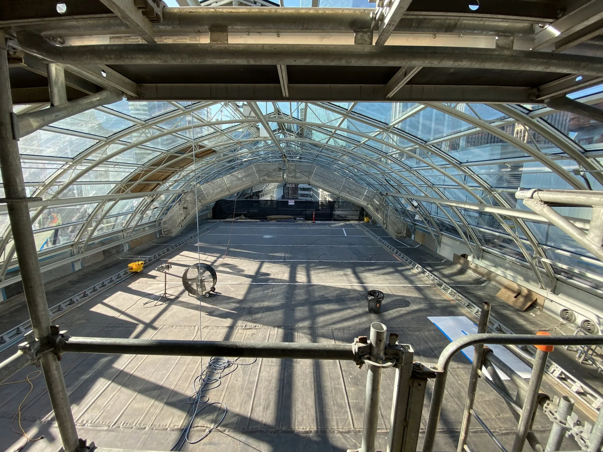 The glazed barrel-vault skylight seen from inside, showing the curved steel arches carrying the glass